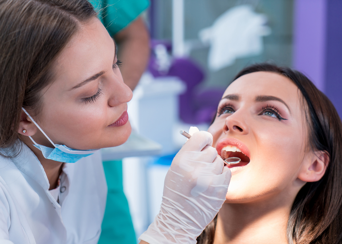 Dentist performing oral cancer screening